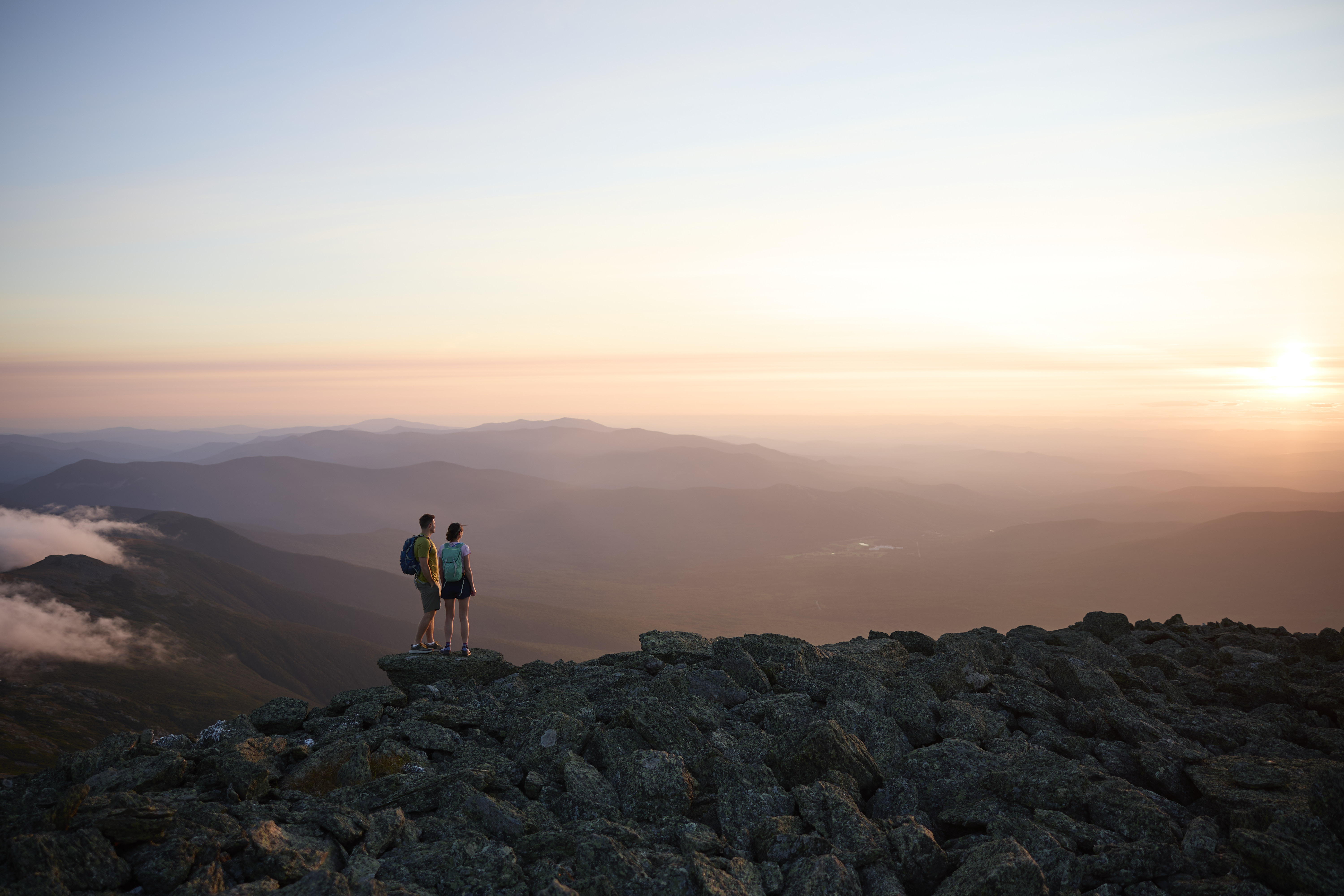 Two people on Mountain top watching sun set